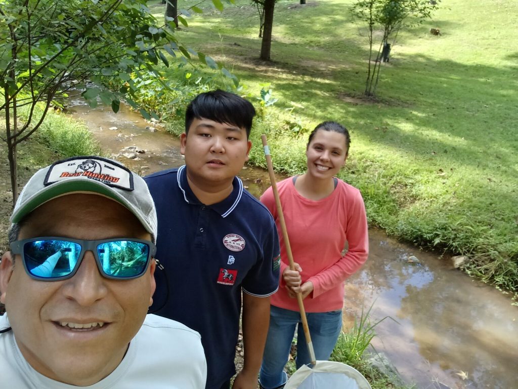 From left, Dr. Adrian Vasquez with Mercer University students Andy Yin and Bryce Williams after a day in the field collecting aquatic organisms.