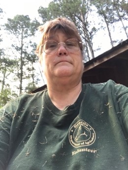 Picture of Rosmarie Kelly, PhD MPH outdoors wearing a dark green volunteer T‑shirt.